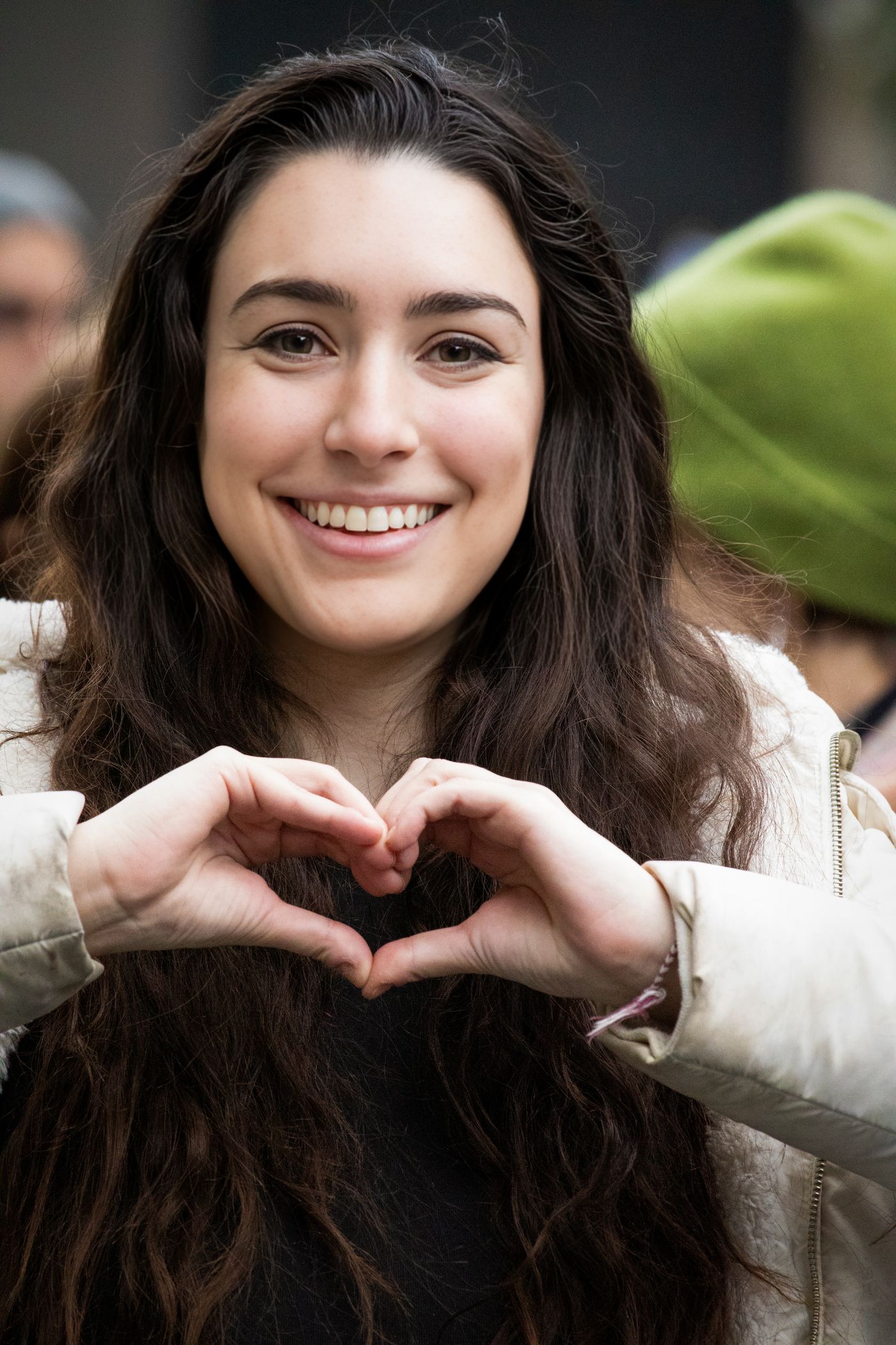 Smiling patient making a heart shape with their hands at Willow Creek Dental